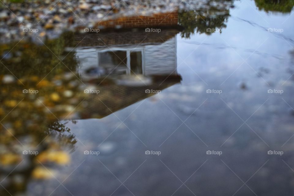 Reflection of house in puddle