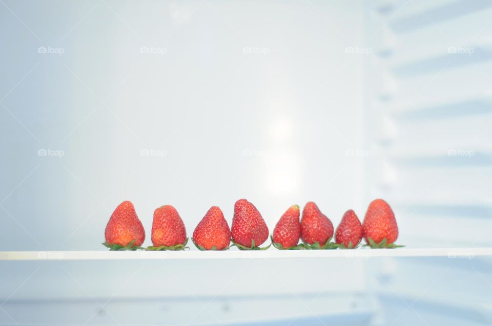 Fresh strawberries in the fridge. Minimalism. Copy space. Healthy food. 