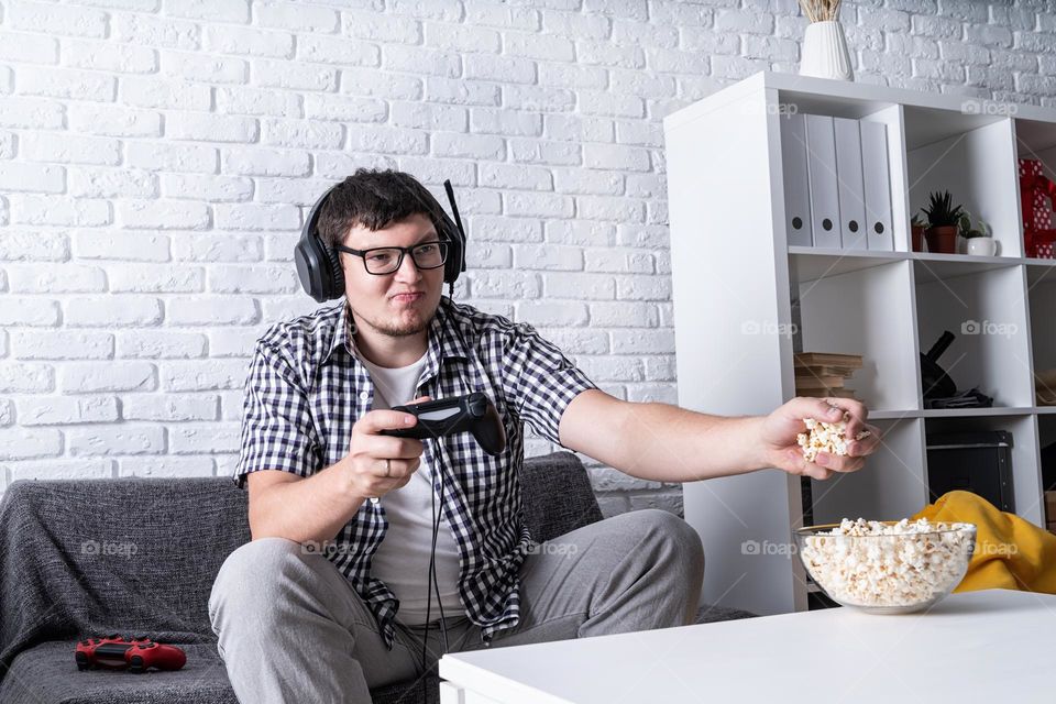 young emotional man playing video games