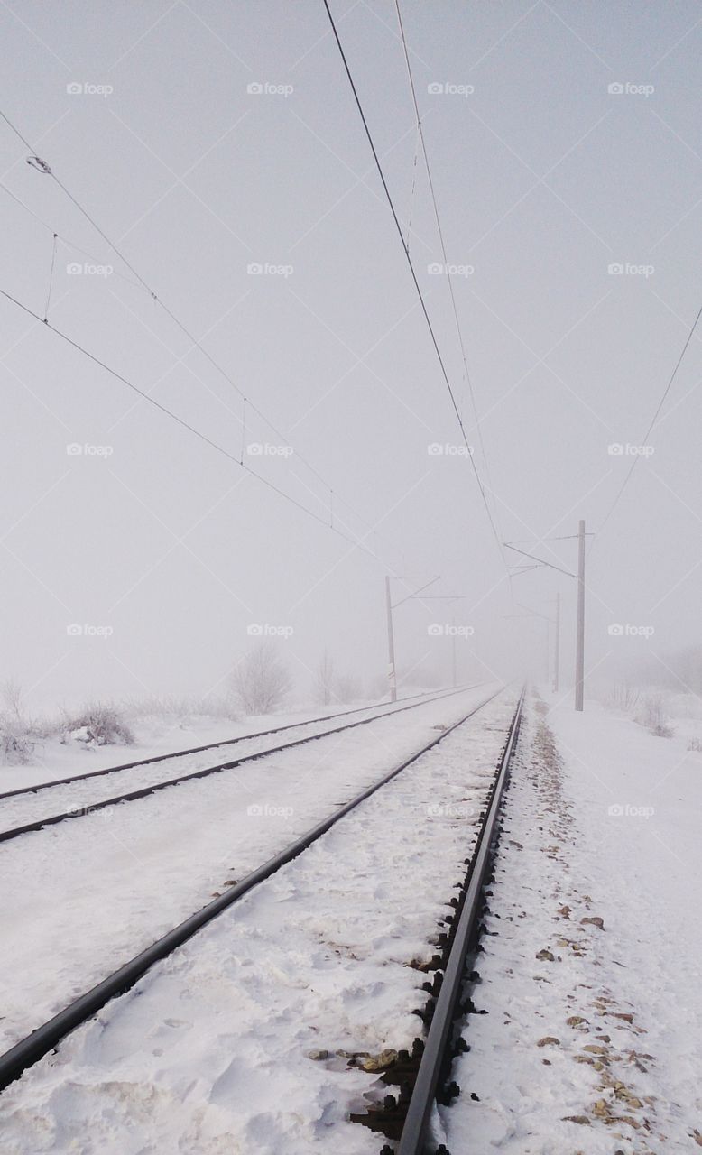 Empty railroad track in winter day