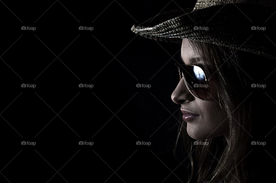beautiful girl in a straw hat and wearing sunglasses
