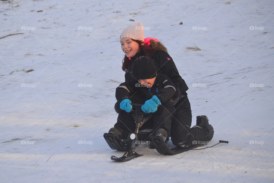 Kids sledding down the hill