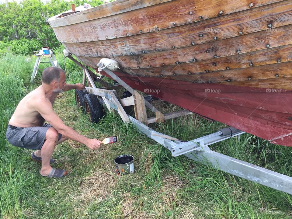 Painting the old wooden boat