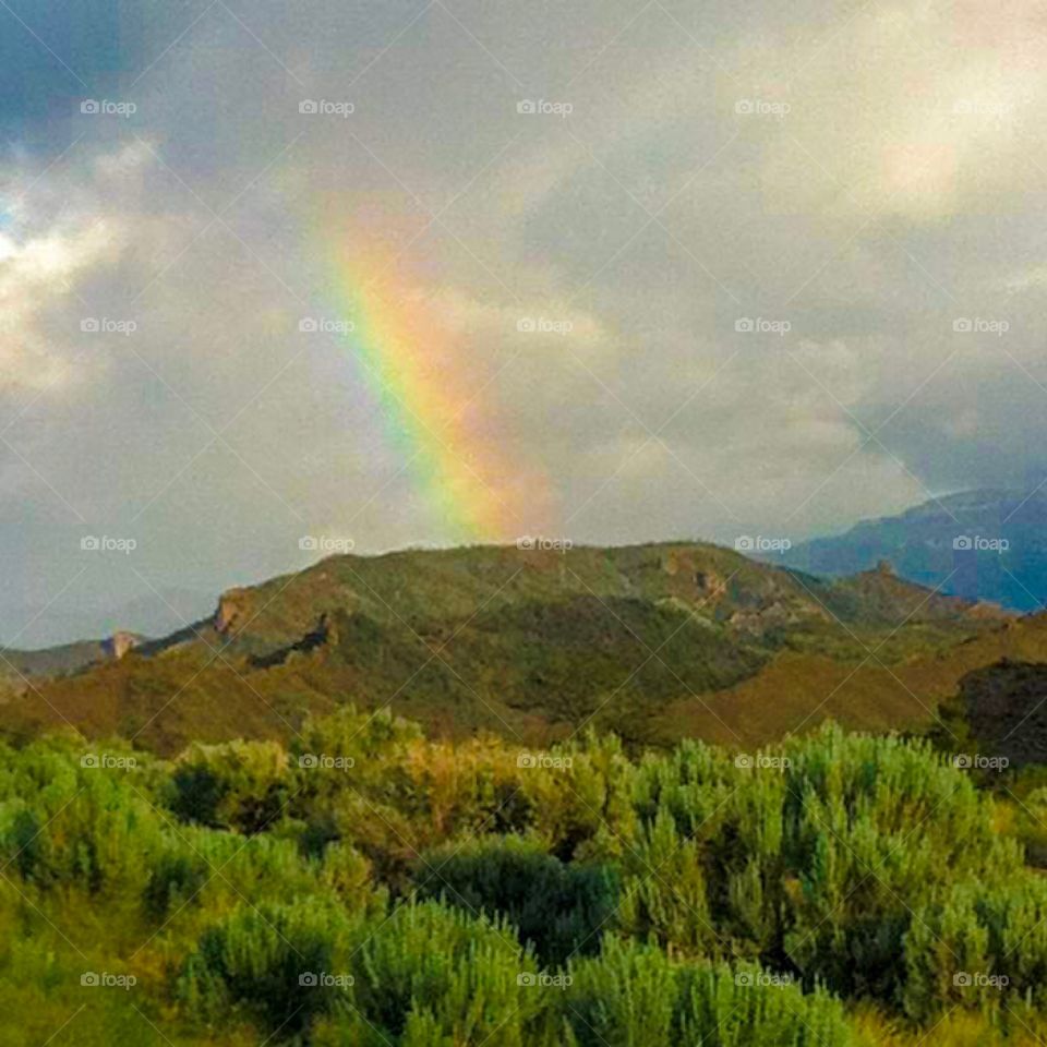 Rainbow over a hill. This photo was taken in Wyoming while I was on a road trip. 