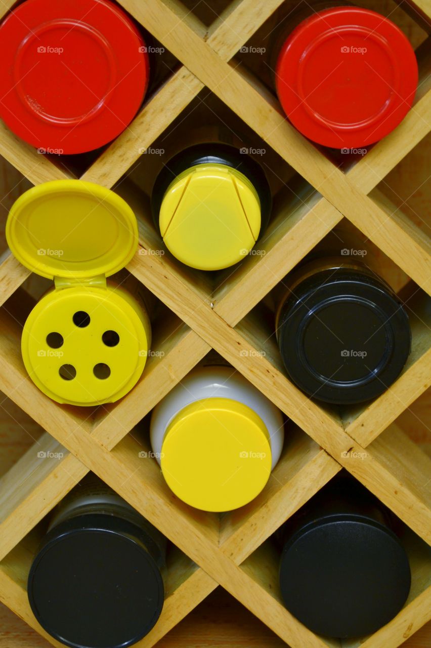 spice rack. Spice rack with yellow, red and black caps