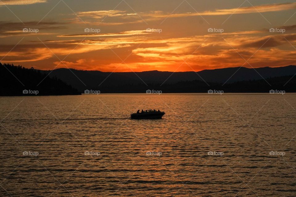A boat packed with party people heads back to dock as the sun sets and the day ends