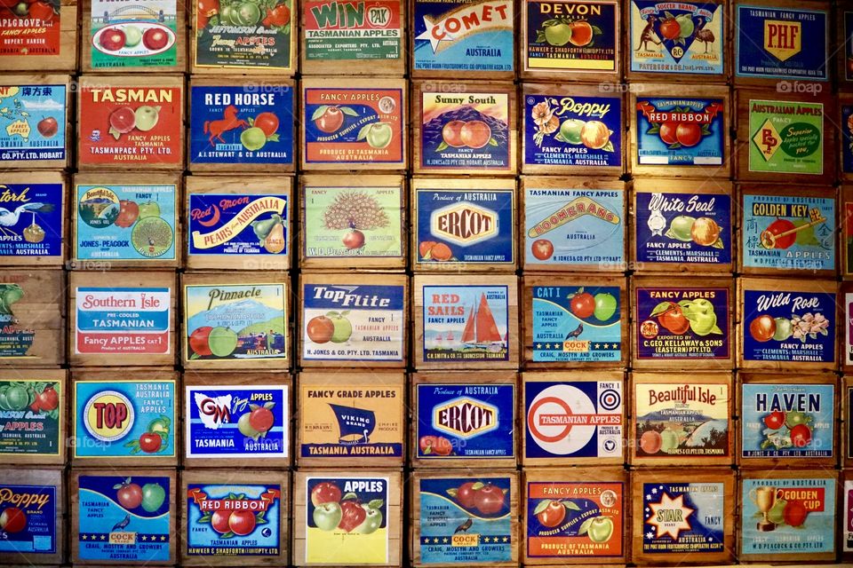 A stack of old Apple Cider crates and labels