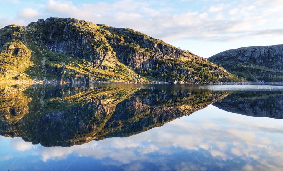 A hill mirrored in water