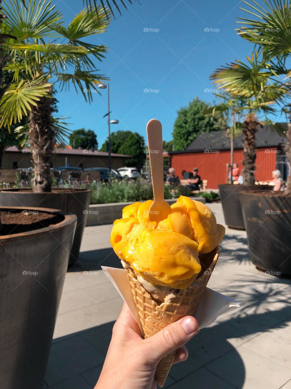 A woman holding a mango ice cream