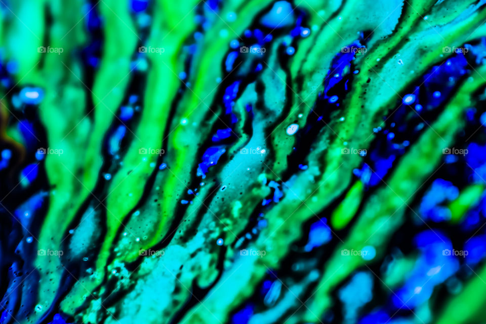 The ink to refill the printer cartridge was spilled onto the white washbasin and the paints blended into abstract drips and patterns.