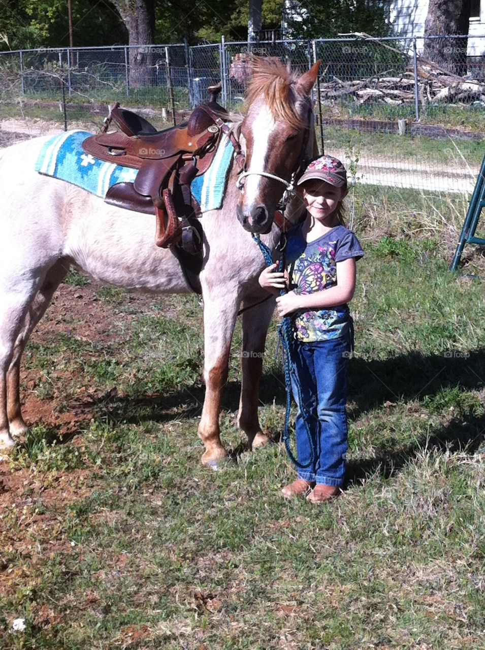 Little cowgirl with her horse