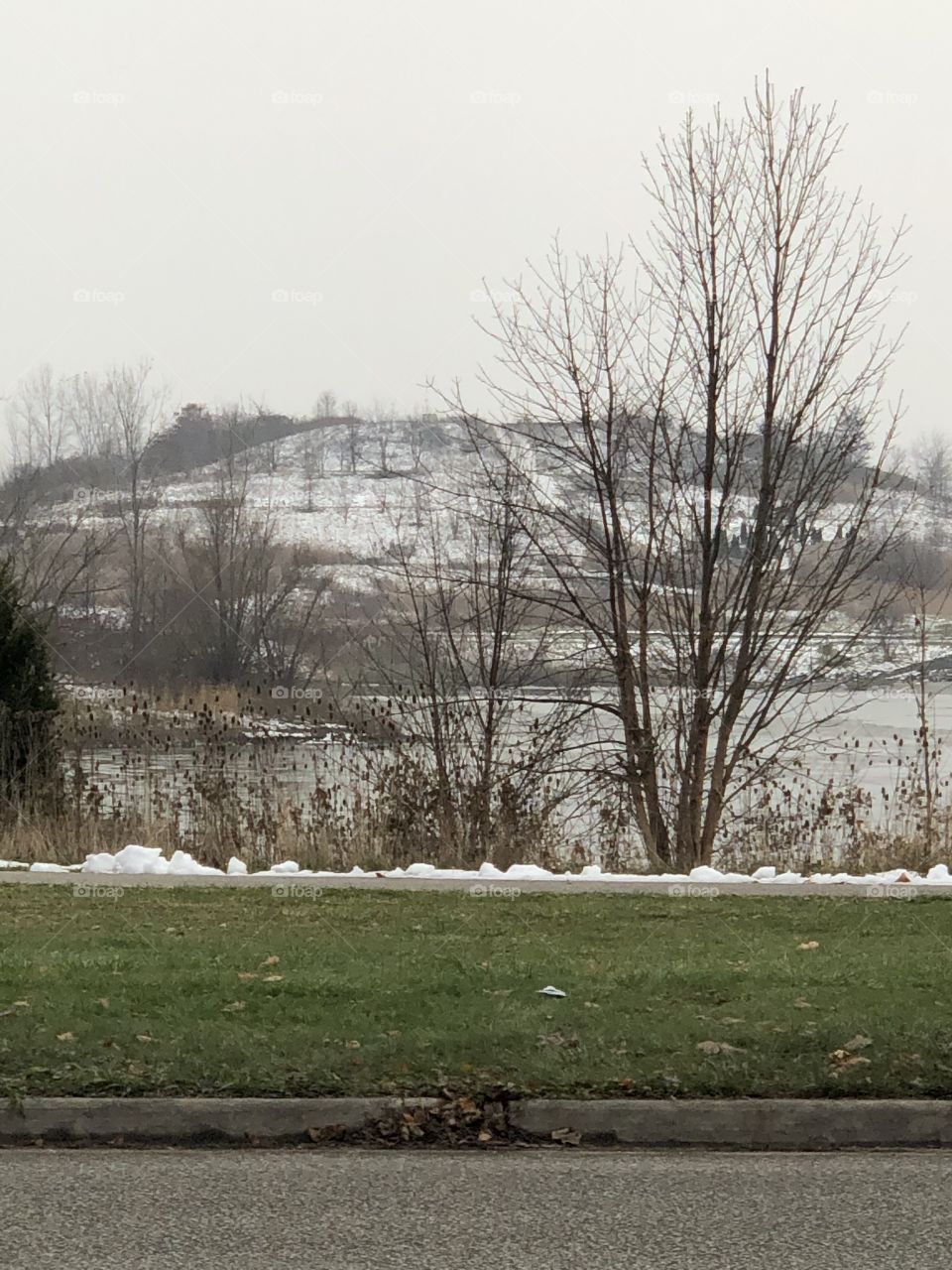 Snow on a small mountain and lake in Canada 