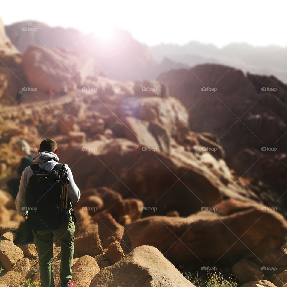 Hiking with a backpack through the Moses mountains in Egypt in the morning 