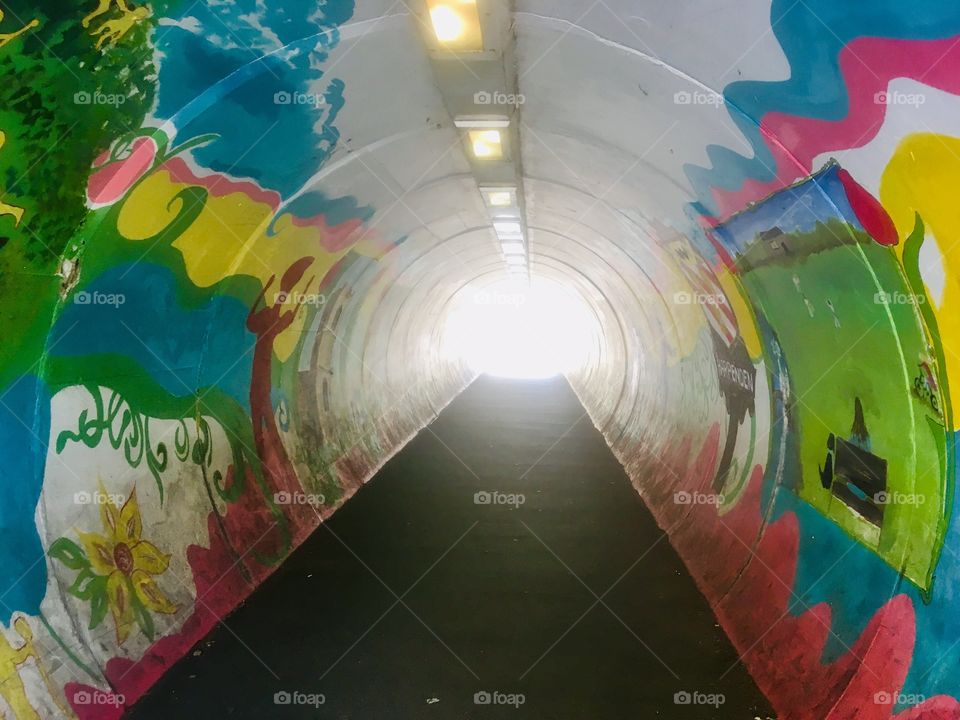 Pedestrian subway tunnel at Harpenden Station, Hertfordshire, with bright coloured interior artwork
