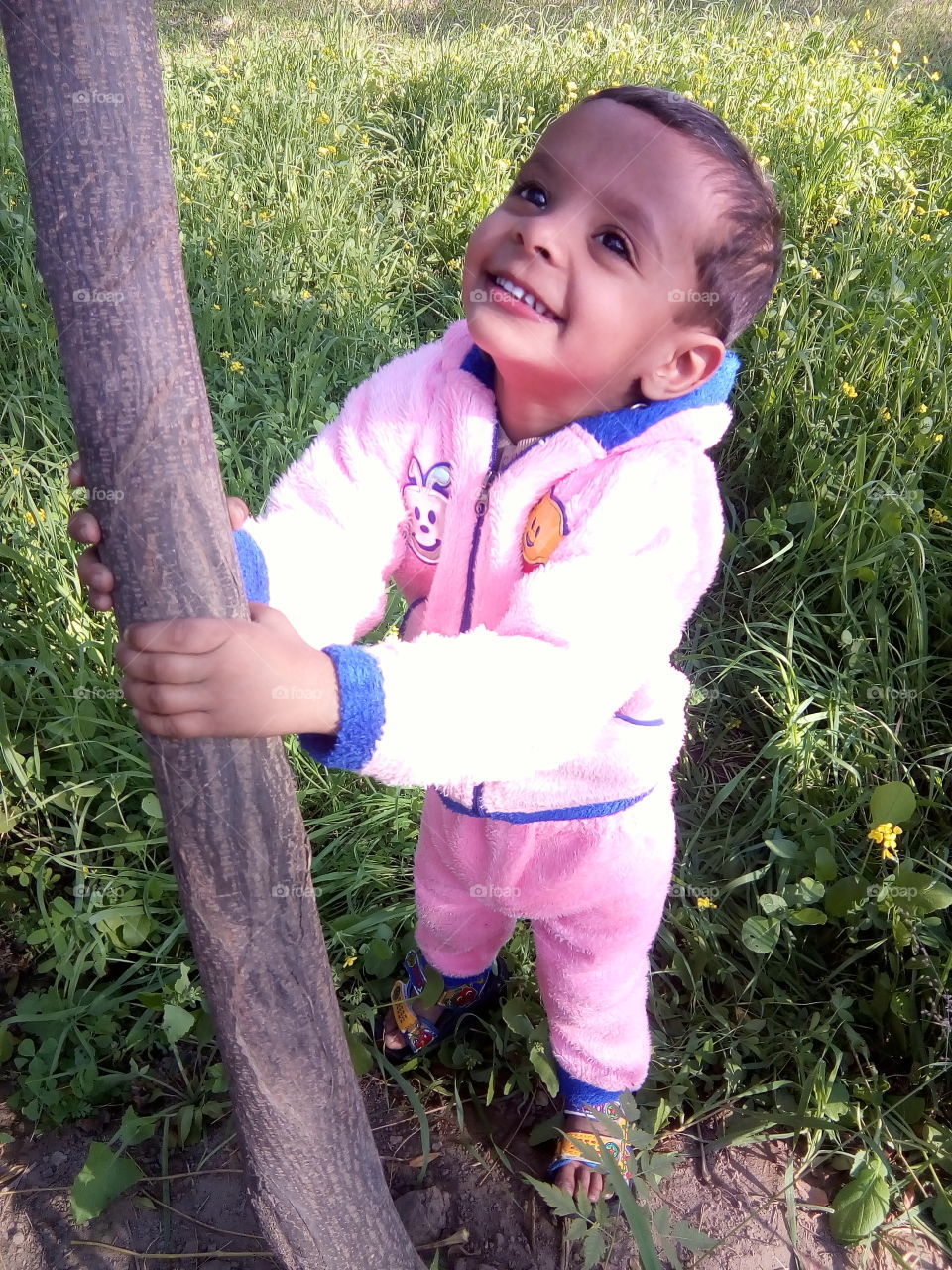 A little boy in a field in happy moments.