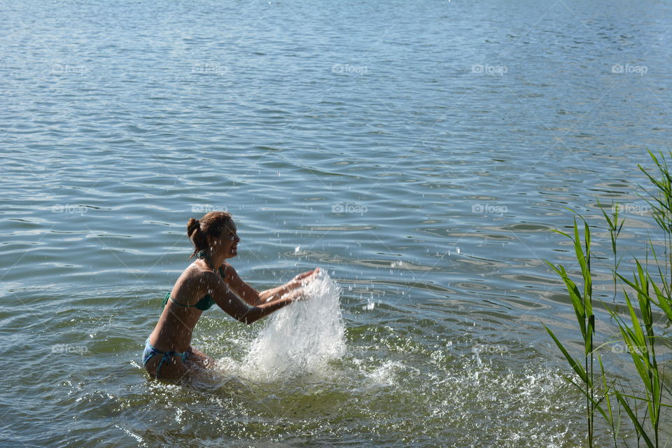 woman in the water lake summer heat, summer vacation