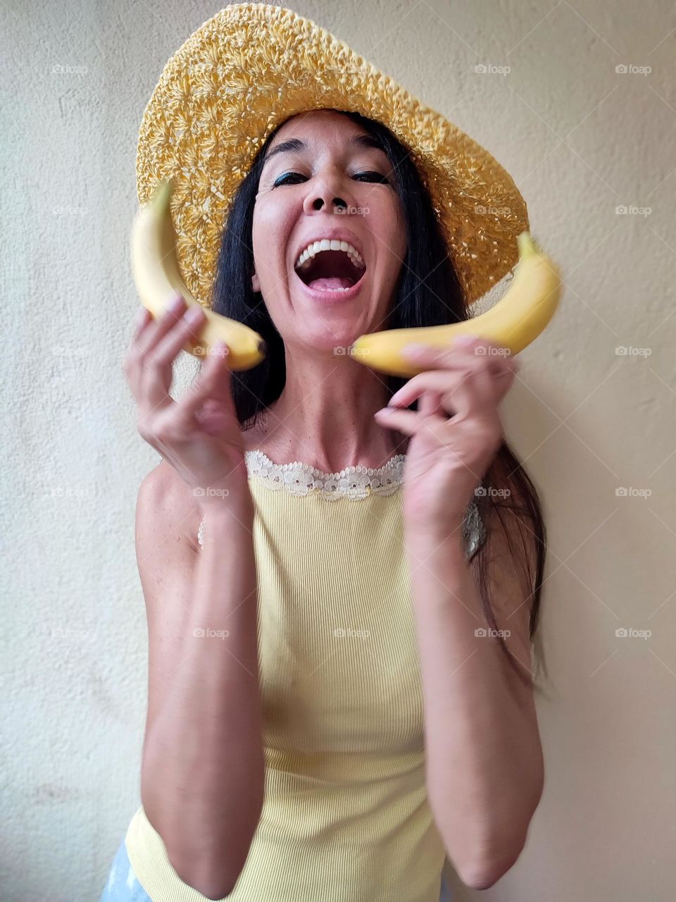 Funny Portrait of Beautiful Smiling Woman with bananas