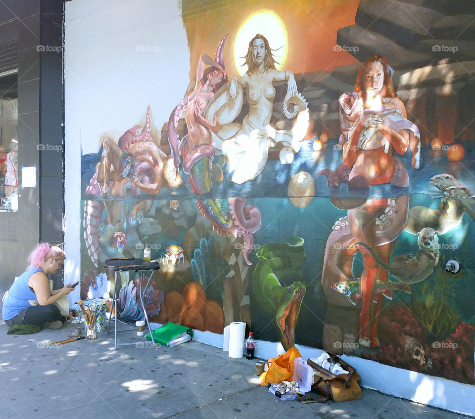 Artist in Seattle taking a break from walls painting