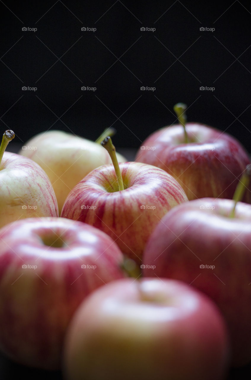 Red apples against black background