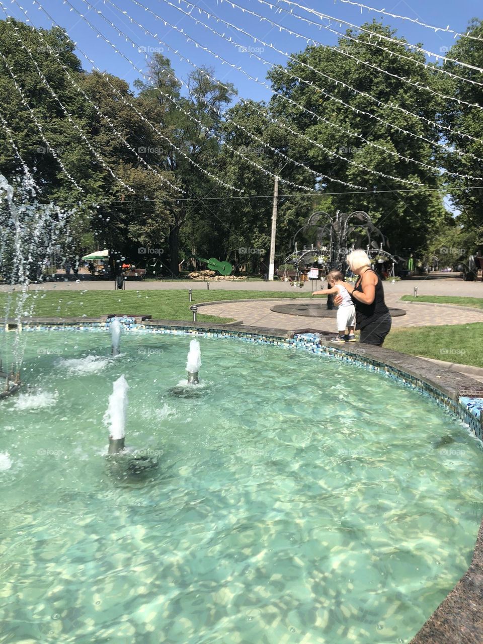 Fountain in the park baby with grandma 