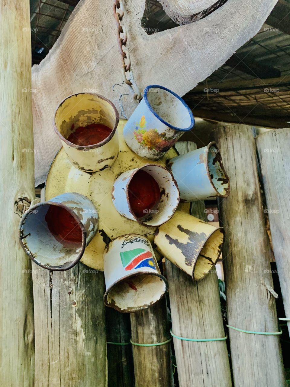 Old metals cups and a plate used as decoration at a scrapyard themed restaurant.