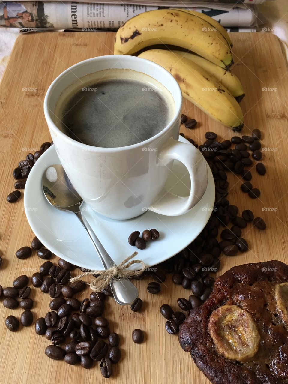 Ripe bananas, beside coffee cup and fresh baked mini liars banana bread 