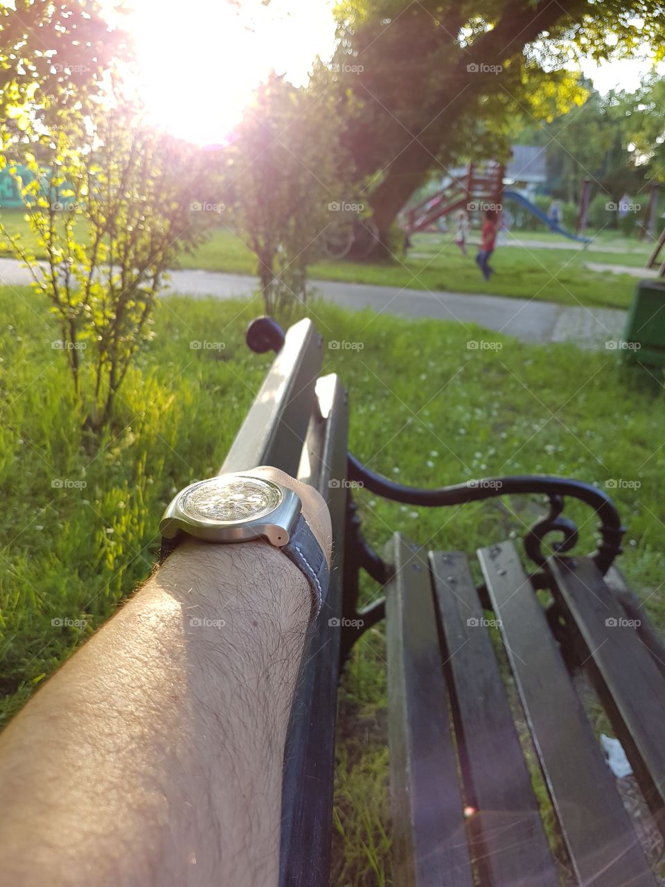 man with a watch in park, sunset