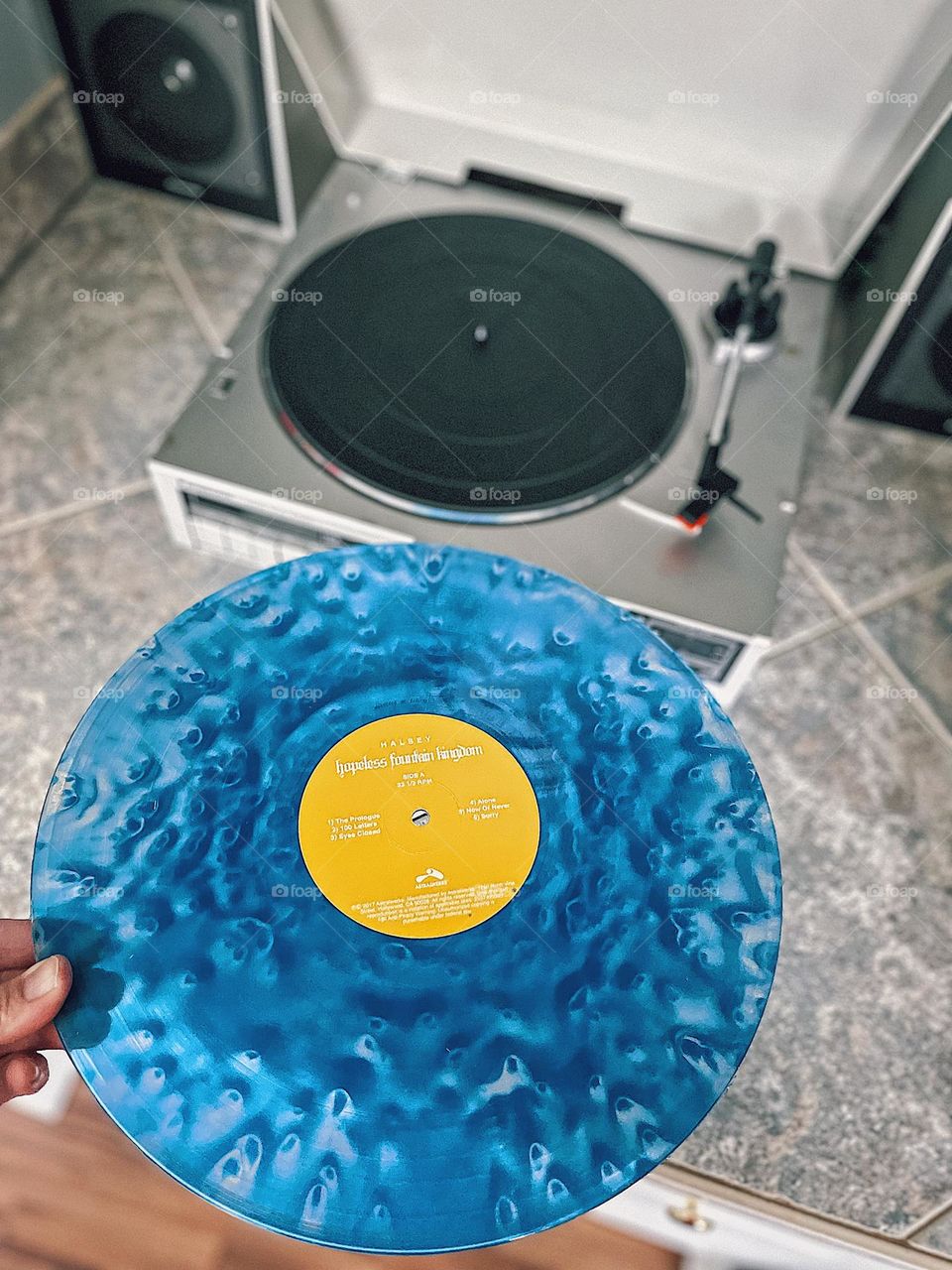 Woman’s hand putting a record on to play music, using a record player to play music, Halsey record, circles in everyday life, circular shapes, geometric shapes in life, circles at home, playing music at home, nostalgic music, record player at home 