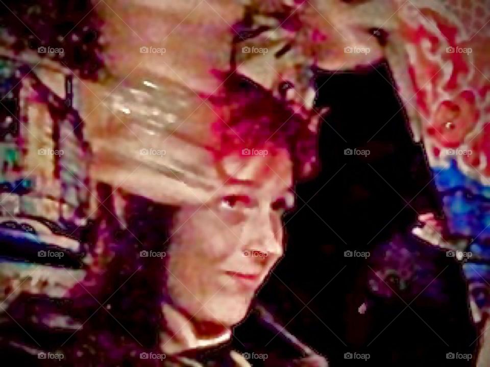 This is a capture in mid motion while making dance moves swinging an assembly of gold bangles around. The vibe that is created reminds of a Buddhist temple. 2009. Hypnotic Productions