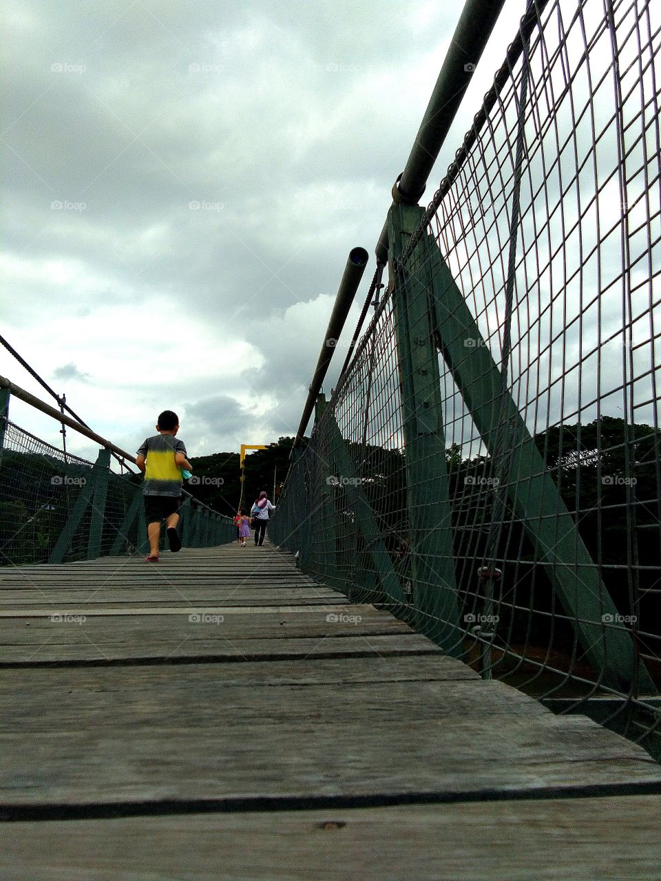 A suspension bridge is a type of bridge in which the deck is hung below suspension cables on vertical suspenders. The first modern examples of this type of bridge were built in the early 19th century