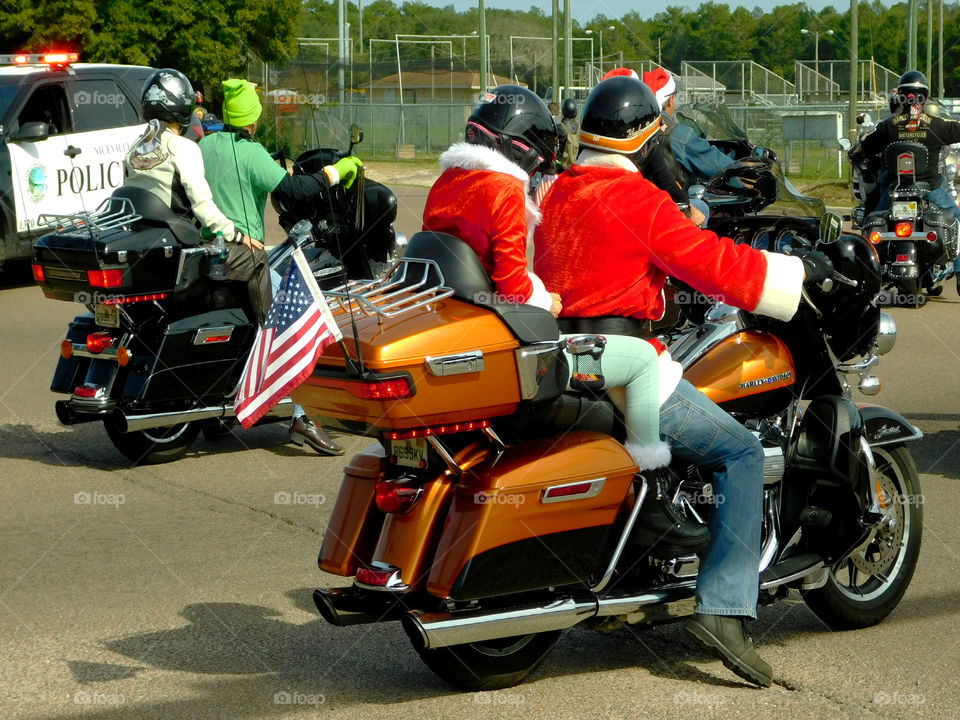 Mr. And Mrs. Santa Claus riding their motorcycle to the fundraiser for the Children's Advocacy Center!