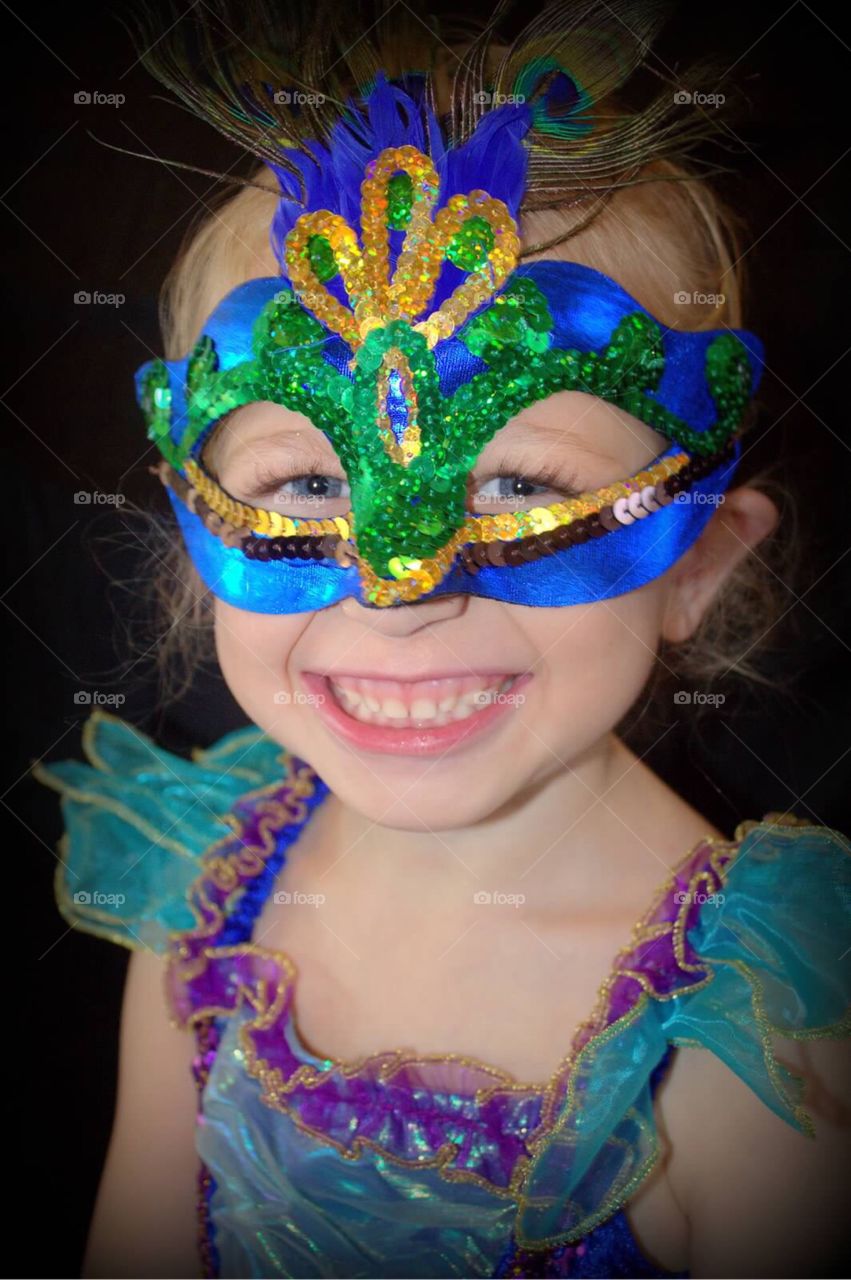 Close-up of a smiling girl wearing eye mask