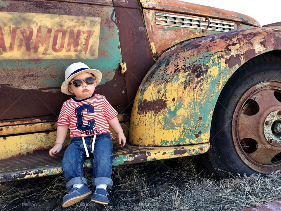 Youngest son by vintage truck next to old creamery