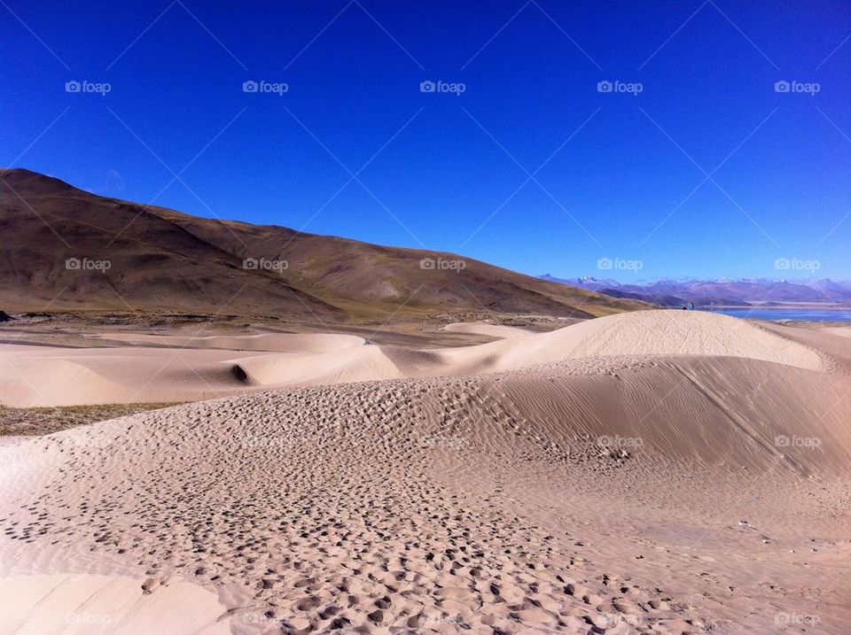 Sand dune against clear sky