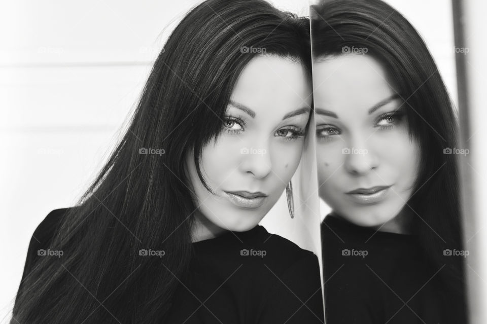 Reflection of a beautiful woman in mirror