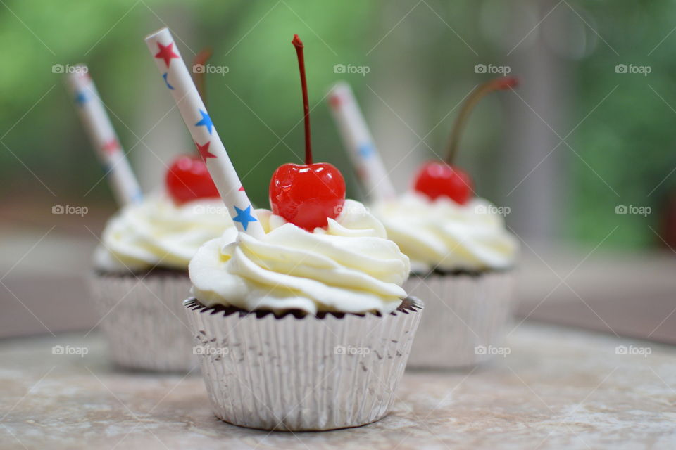 Delicious cupcake with cherry