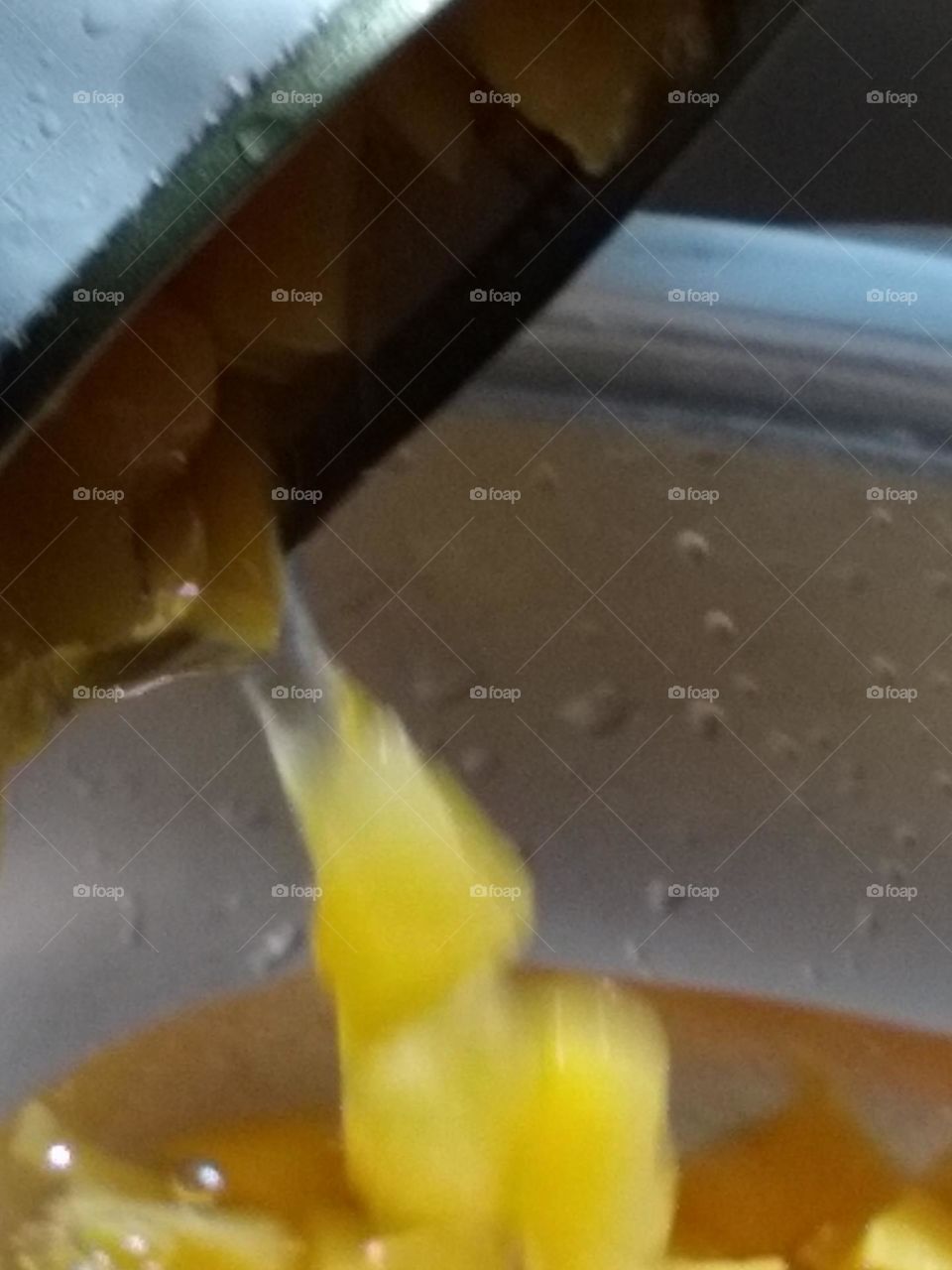 Peaches in water pouring out slowly while I take pictures.