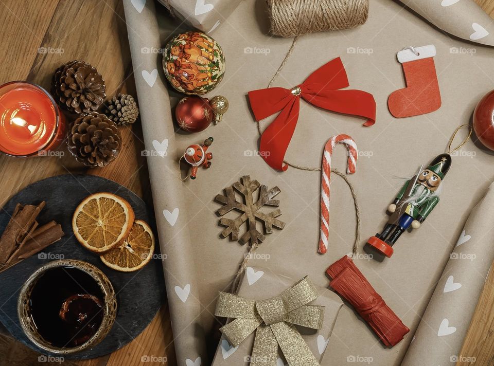 Flat lay of wrapping gifts with mulled wine and festive accessories 