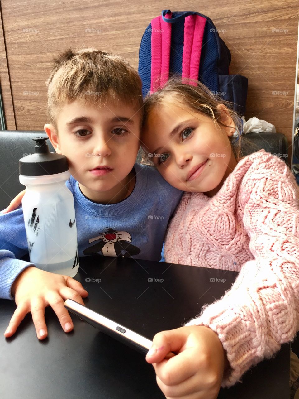 Sibling sitting together at restaurant