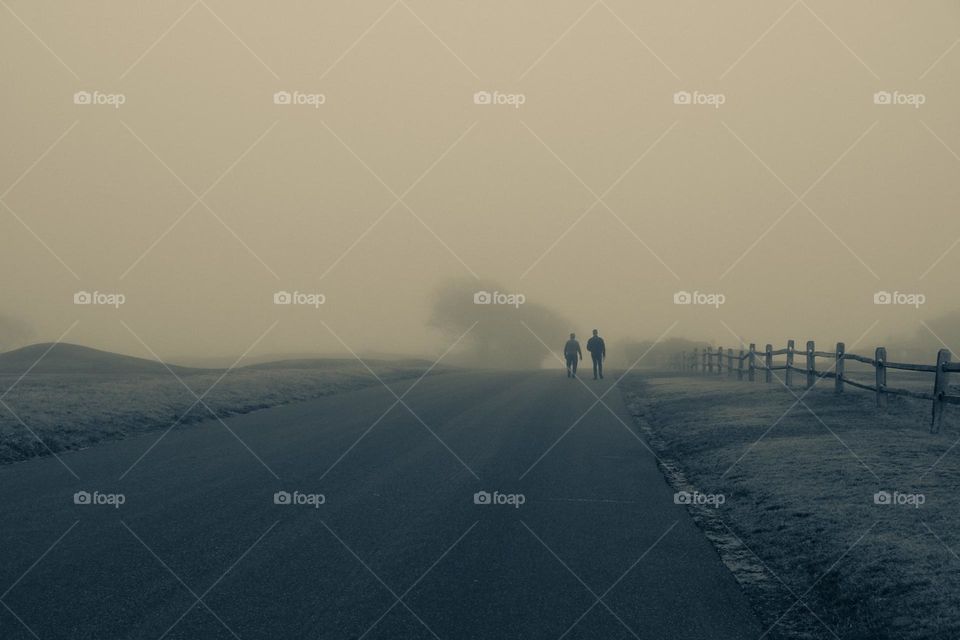 Father and son walking down the road in the fog, father and son walking together, foggy family portrait, moody portrait of father and son 