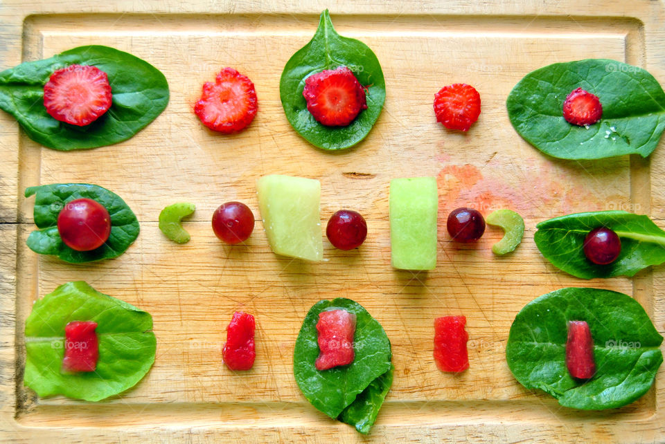 flat lay slices of fruits and leafy veggies