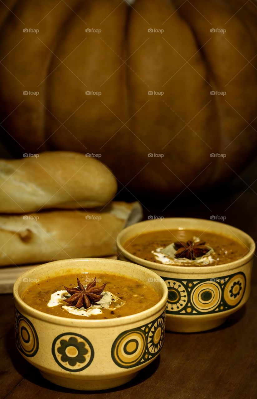 Pumpkin and lentil soup, with garnish and fresh bread