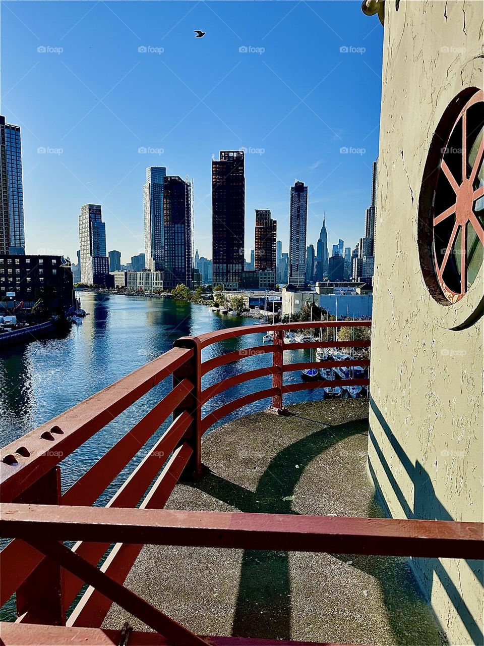 This is beautiful “Newtown Creek” seen from the center outpost of the pedestrian lane on the “Pulaski Bridge” that connects “Greenpoint”, Bklyn to LIC, Queens. You can see all the way to “Manhattan” from here. 2023. Hypnotic Productions