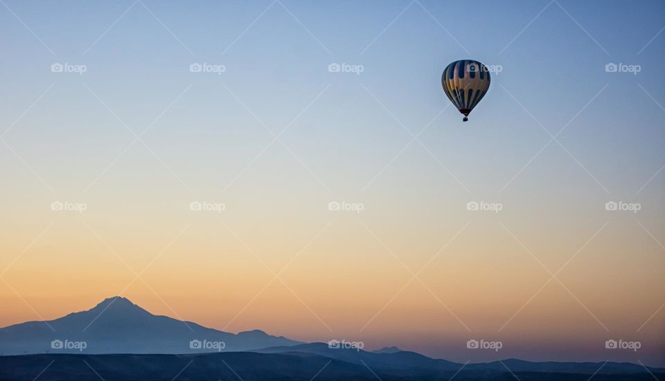 hot air balloon in the air by sunrise