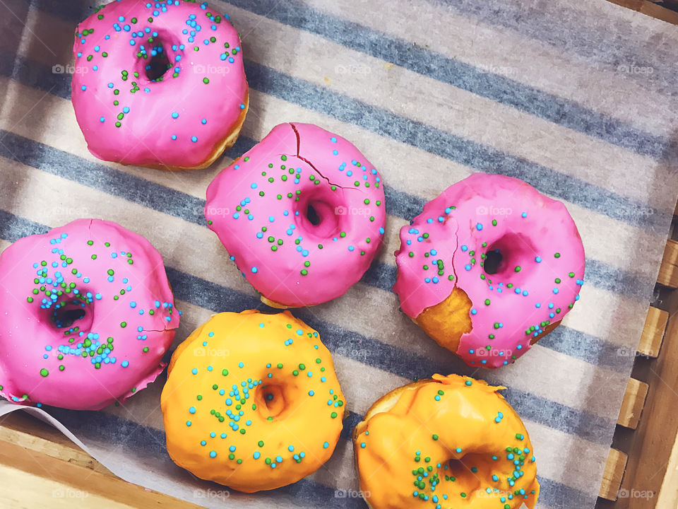 Fresh baked Pink and yellow donuts 