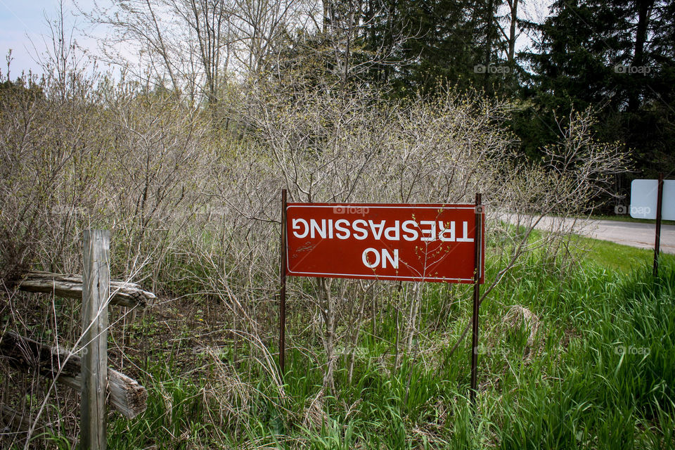 Upside down sign and meaning, no trespassing