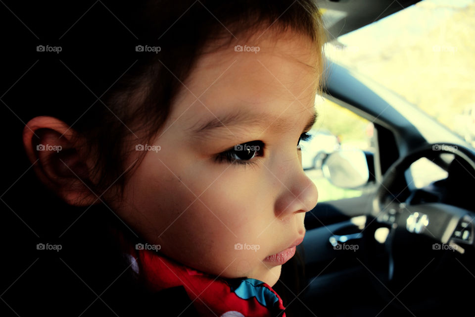 Close-up of a girl sitting in car