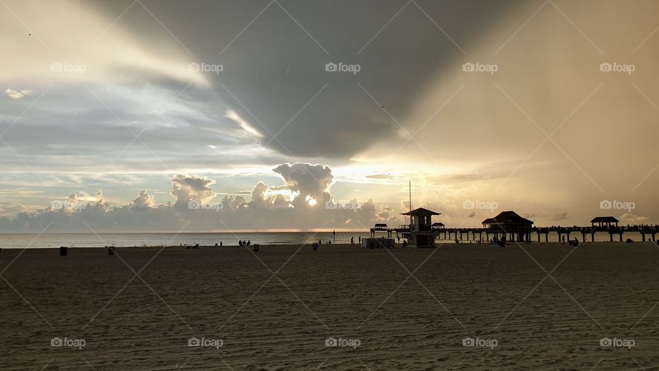 Sunset and rain clouds on the beach , weather 