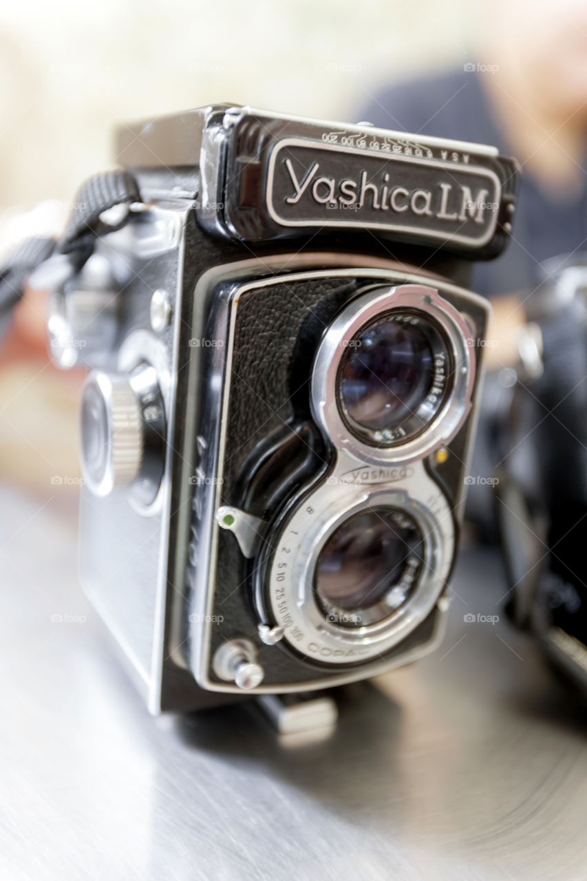 Antique old film camera with black leather exterior