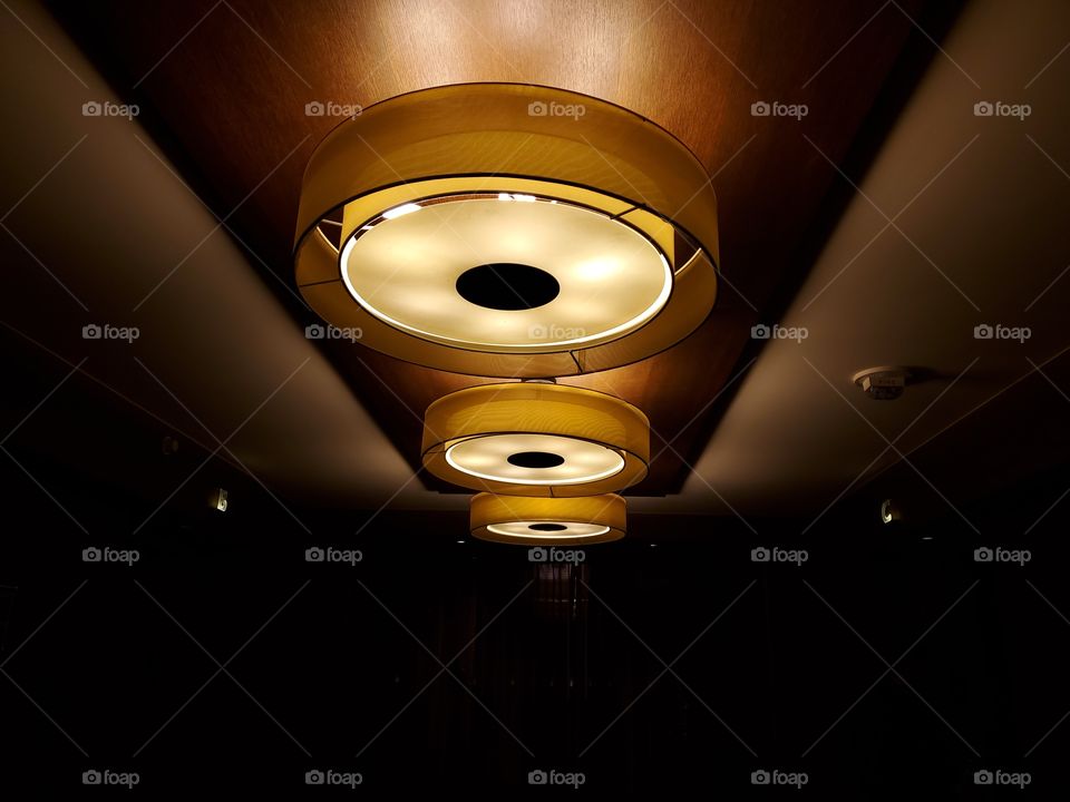 Three circular shaped ceiling lights fixtures indoors.